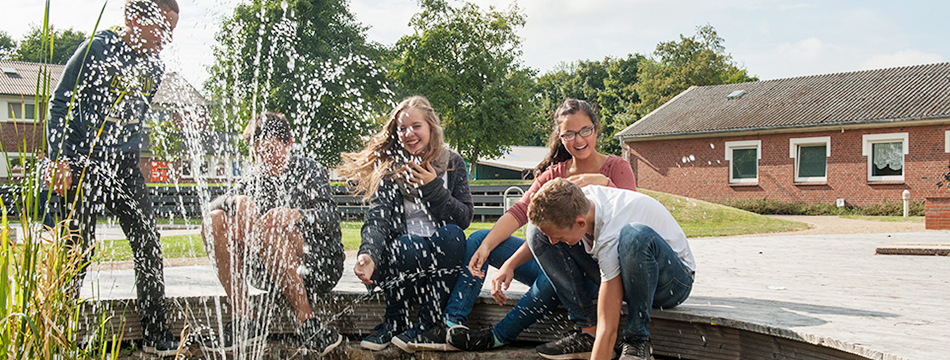 st peter ording 950×350 1 Junge Menschen lachen und spielen in einer Fontäne. Nordsee-Internat in St. Peter Ording